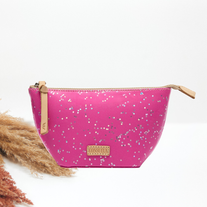 A bright pink cosmetic pouch with a silver glitter star pattern, tan leather zipper pulls, and a gold-tone Consuela brand plaque, shown on a white background.