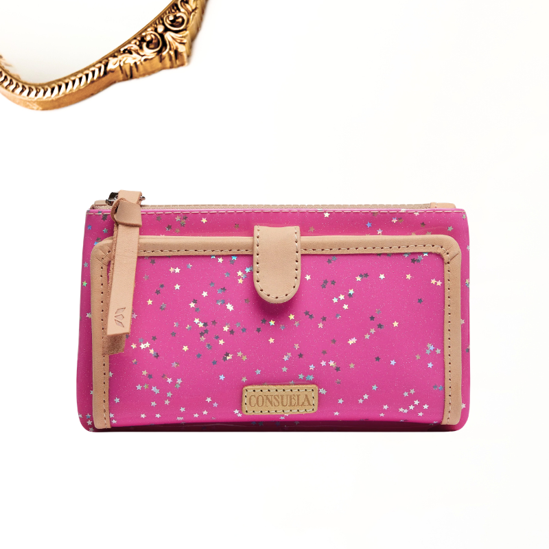 A pink zip-around wallet with a glittery star pattern, beige trim, and a small front tab, shown on a white background with a gold chain partially visible at the top left.