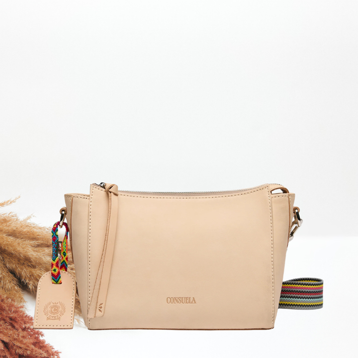 Beige handbag with a colorful strap on a white background