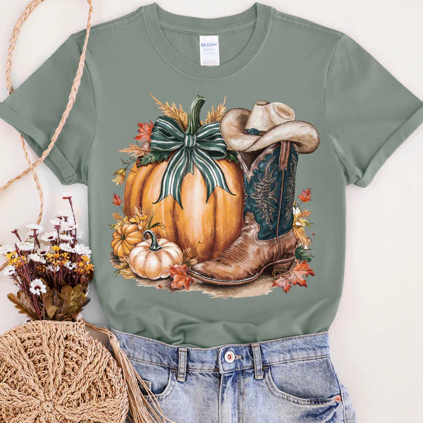 Green t-shirt with a pumpkin and cowboy boot design on a white background