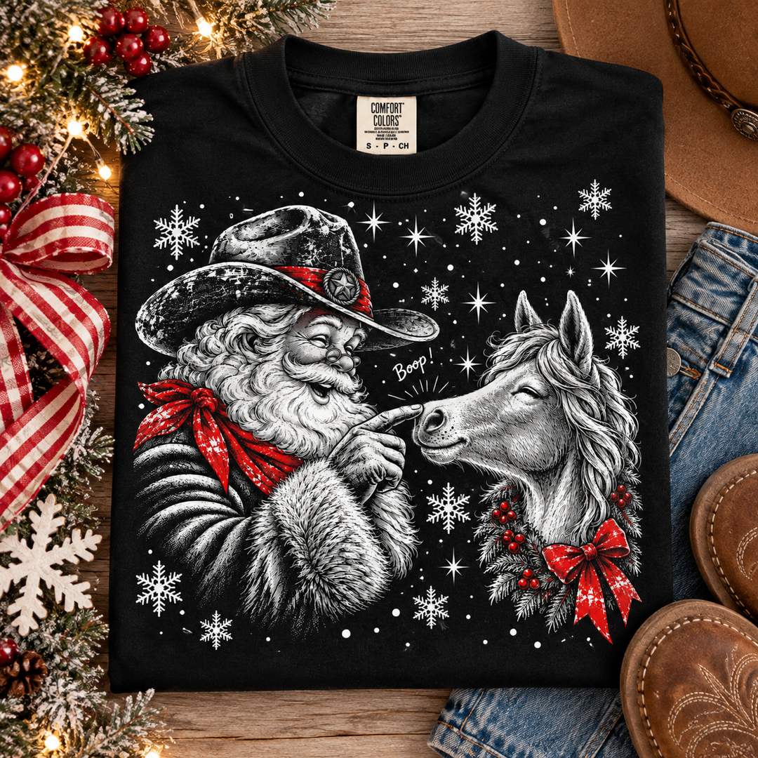 Cowboy Santa Boop Christmas graphic tee or sweatshirt on black with a black and white cowboy Santa booping a horse on the nose