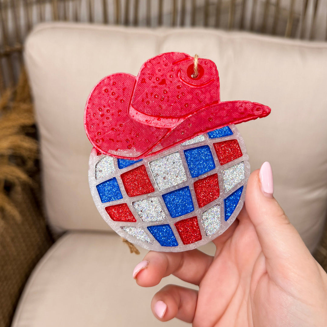 Rustic chair background with a disco ball with red cowgirl hat in red, silver and blue!
