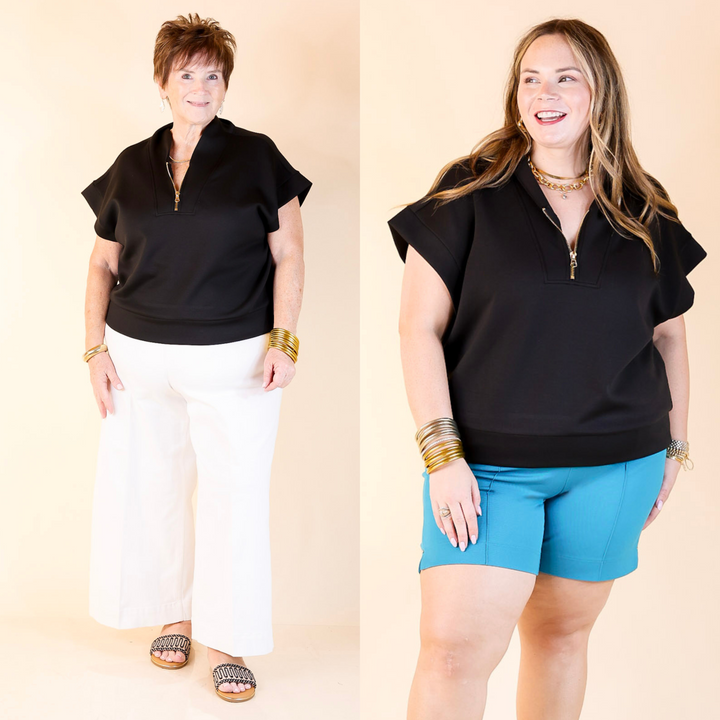 Polished meets practical—this black half zip shirt features a gold zipper, classic collar, and easy, elevated style. Sizes in S/M and L/XL.