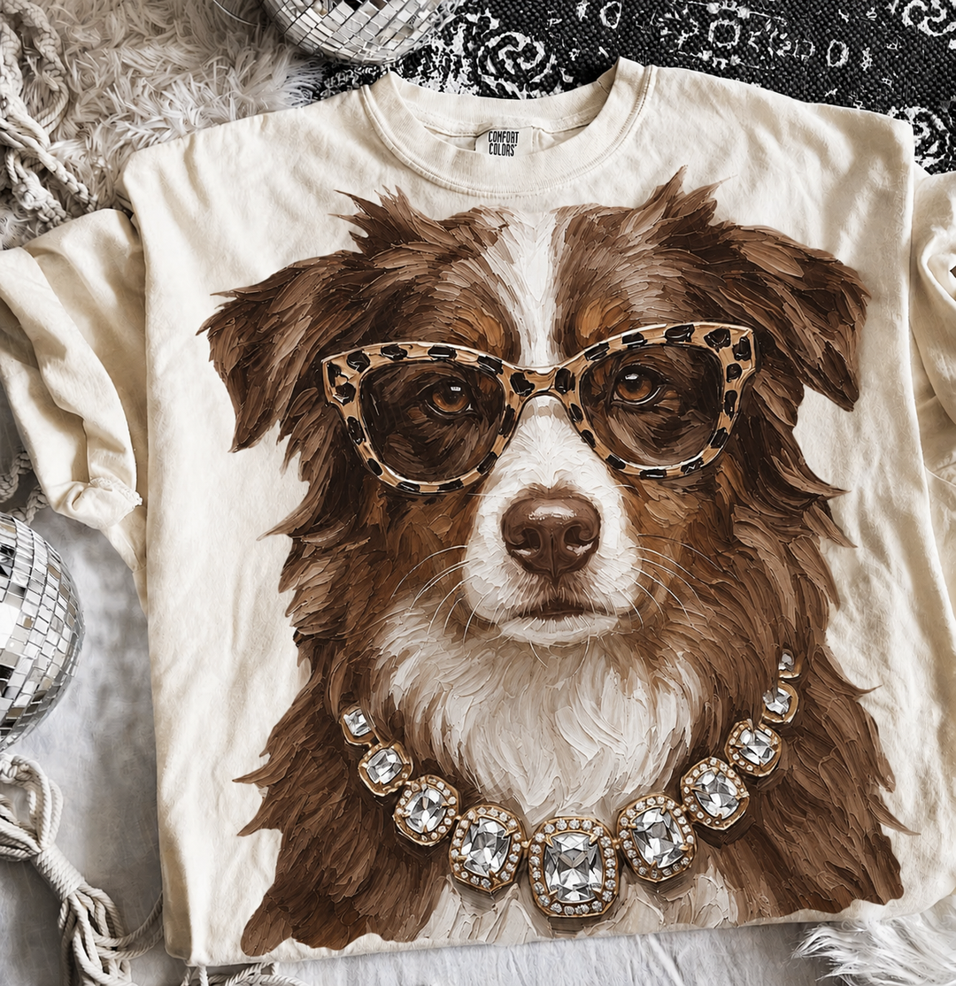 Boujee Brown and White Aussie graphic tee or sweatshirt on ivory with an Australian Shepherd in leopard sunglasses and a crystal necklace