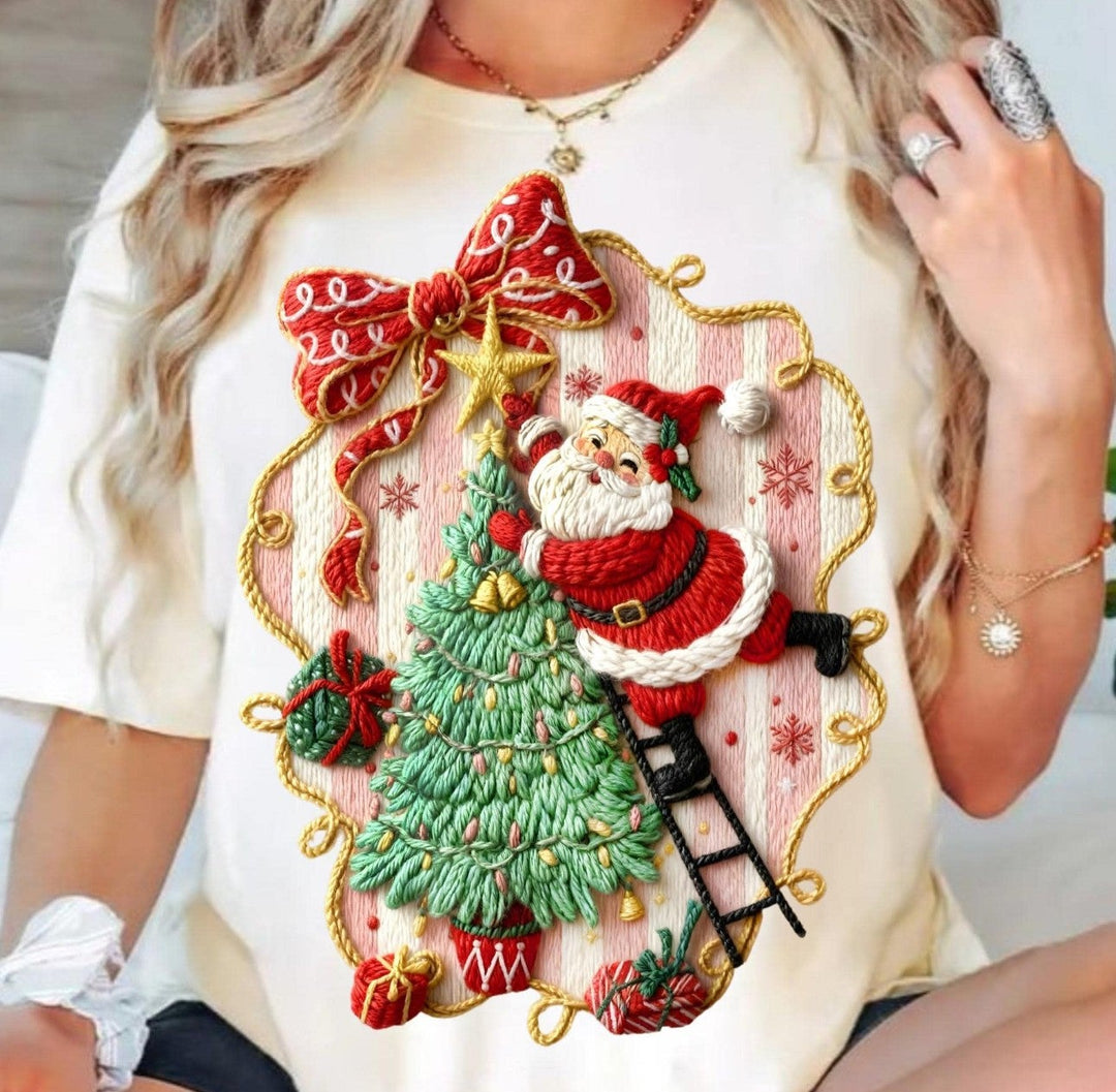 Faux Yarn Santa on Tree Christmas graphic tee or sweatshirt on ivory with Santa on a ladder decorating a tree