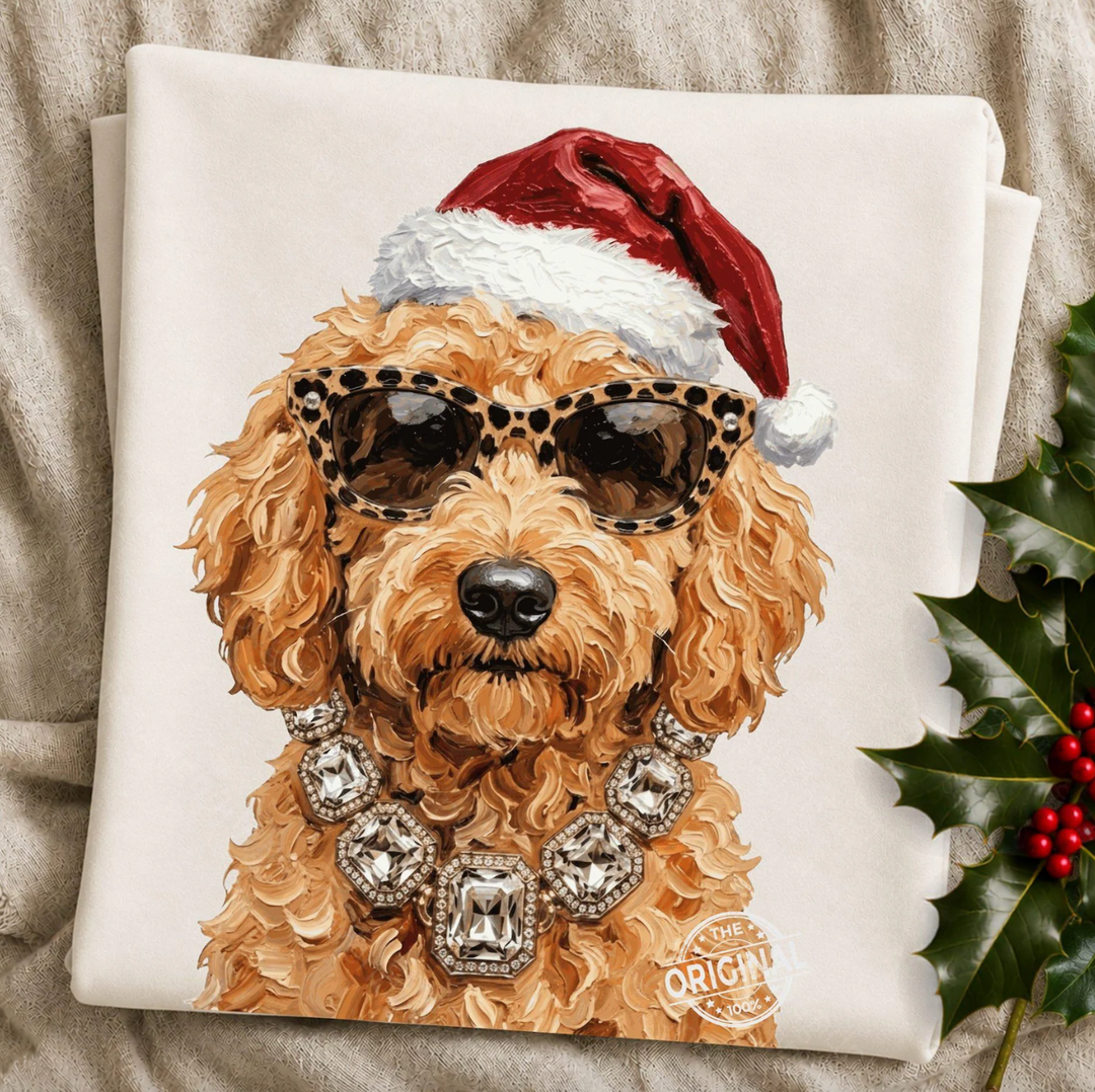 Santa Pup Doodle Christmas graphic tee or sweatshirt featuring a apricot curly-coated Doodle in a Santa hat, leopard sunglasses and crystal necklace on ivory