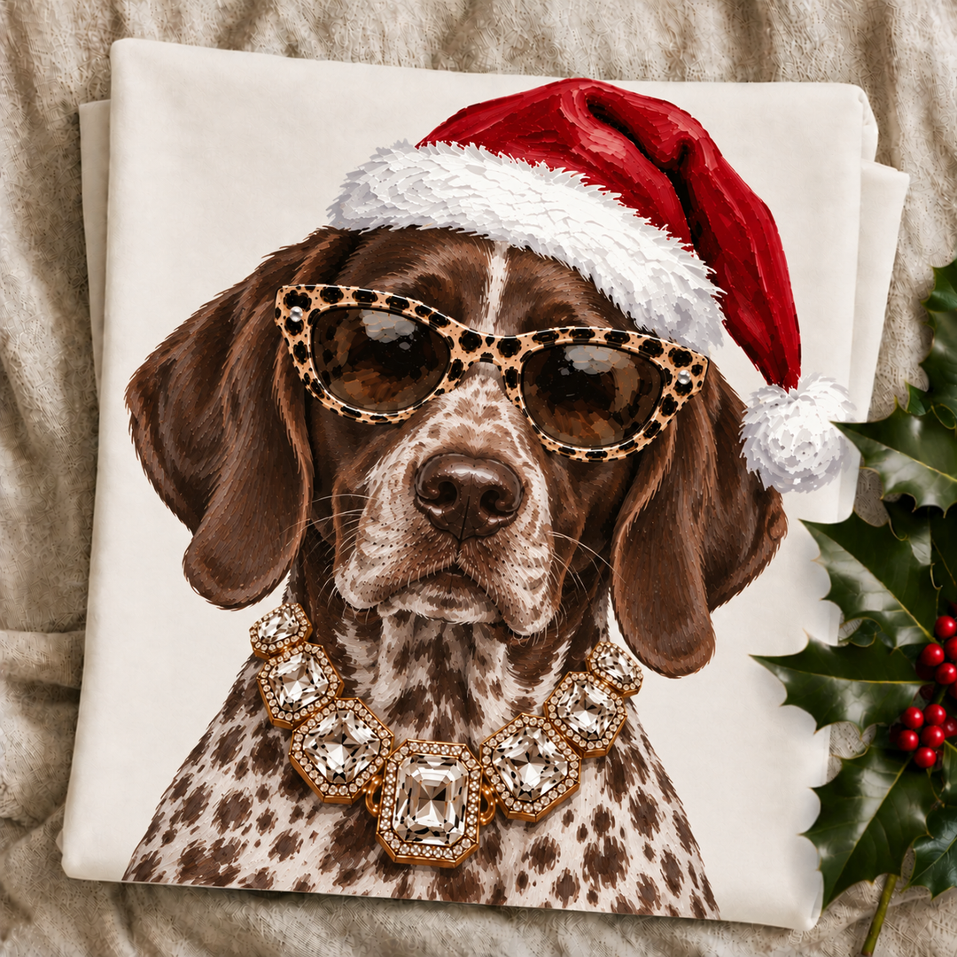 Santa Pup German Shorthair Pointer Christmas graphic tee or sweatshirt featuring a liver and ticked German Shorthaired Pointer in a Santa hat, leopard sunglasses and crystal necklace on ivory
