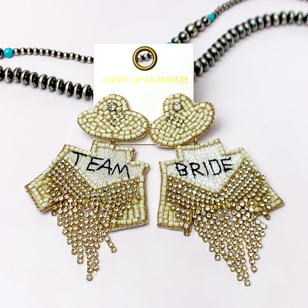 Beaded Team Bride Earrings with Clear Crystals in White with Cowboy Hat Studs. Pictured on a white background with beads through the back.