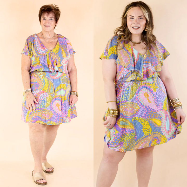 This dress is knee length with a ruffle upper, short sleeves, and an elastic natural waist that will stretch. Available in sizes small through plus size. 