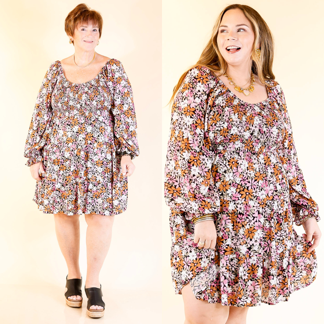 Two women wearing light pink and rust floral dresses against a beige background.