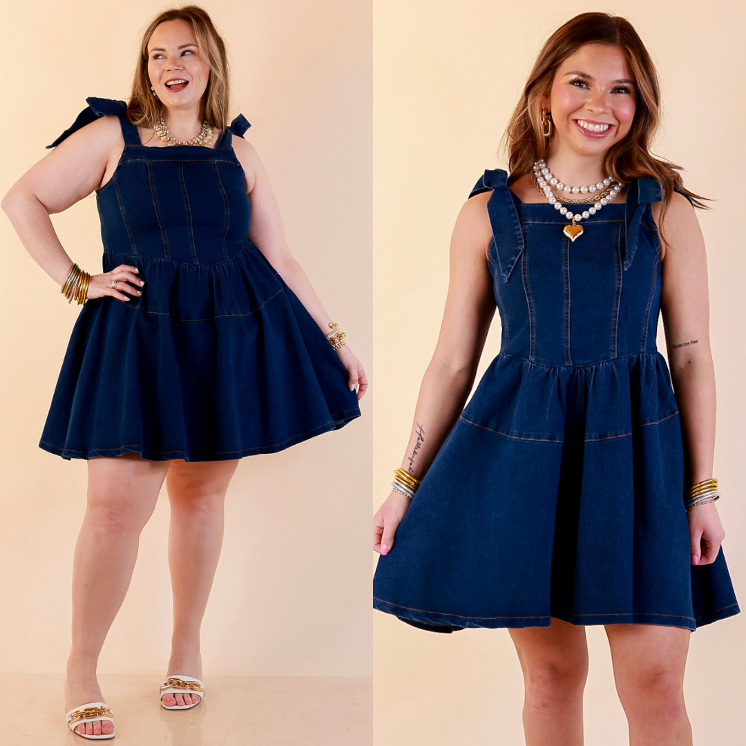 Models are wearing Tie Shoulder Square Neck Tiered Corset Denim Mini Dress in Dark Wash against a beige backdrop. 