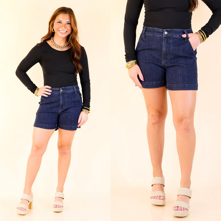 The Denim Prestige shorts feature a high-waisted, tailored fit in dark wash denim for a sleek, polished look. Perfect for both casual and dressed-up styles.
