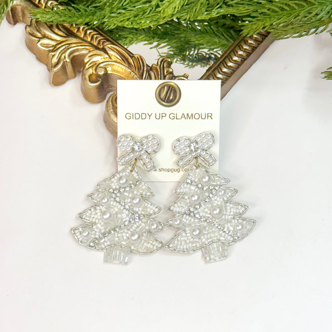 Silver earrings on a 'Giddy Up Glamour' branded card with decorative elements in the background.