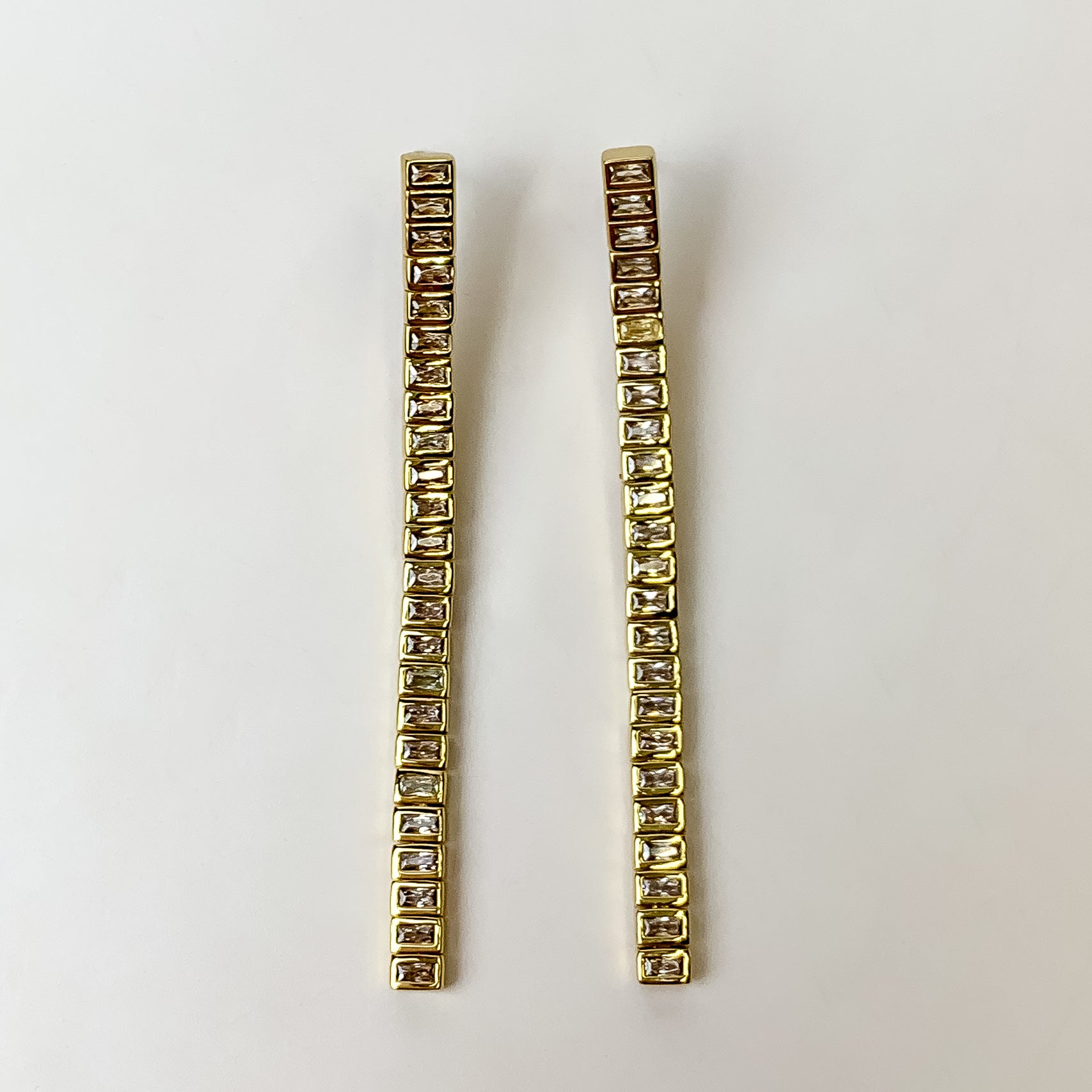 These Gracie Gold Long Tennis Linear Earrings in White by Kendra Scott are pictured on a white background.
