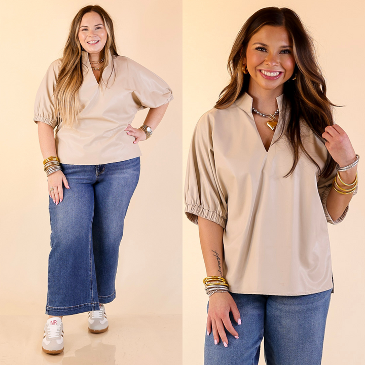 Two women wearing beige faux leather balloon sleeve tops and blue jeans on a beige background