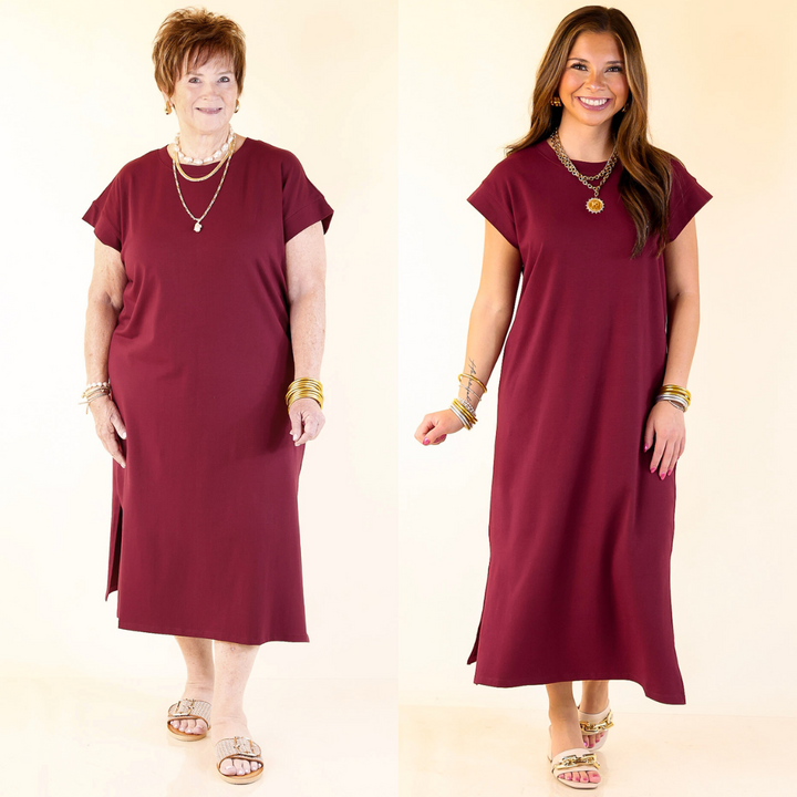 Two women wearing maroon midi tee shirt dresses on a beige background