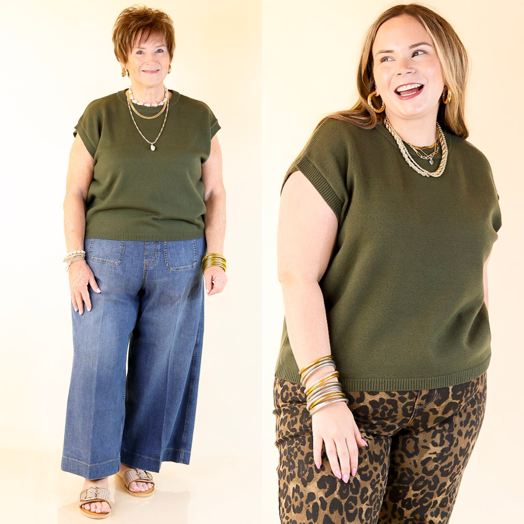 Two women wearing green tops and pants on a plain background