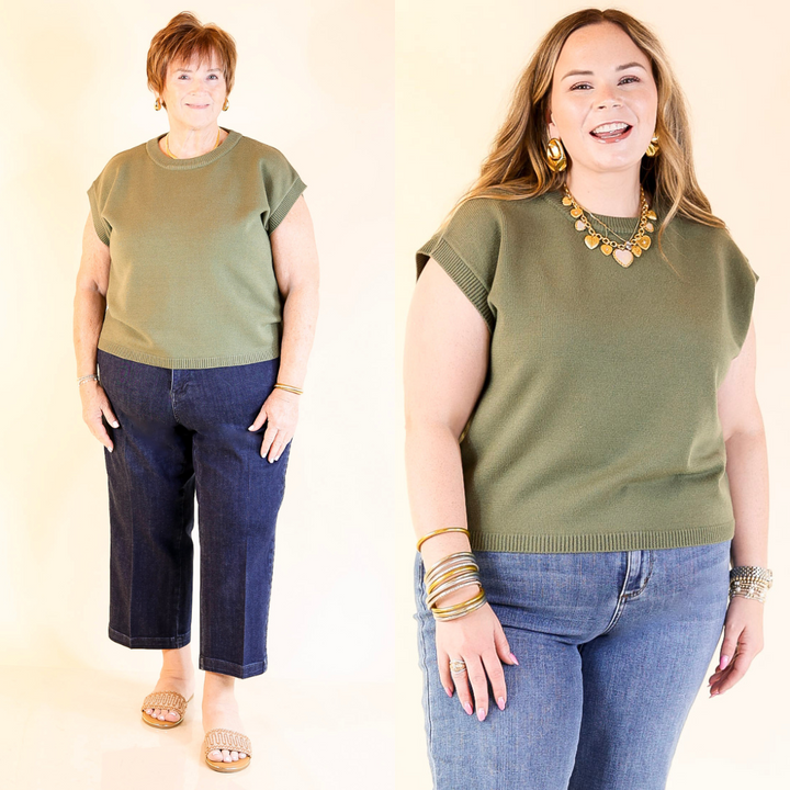 Two women wearing olive green sweater top and blue jeans against a plain background