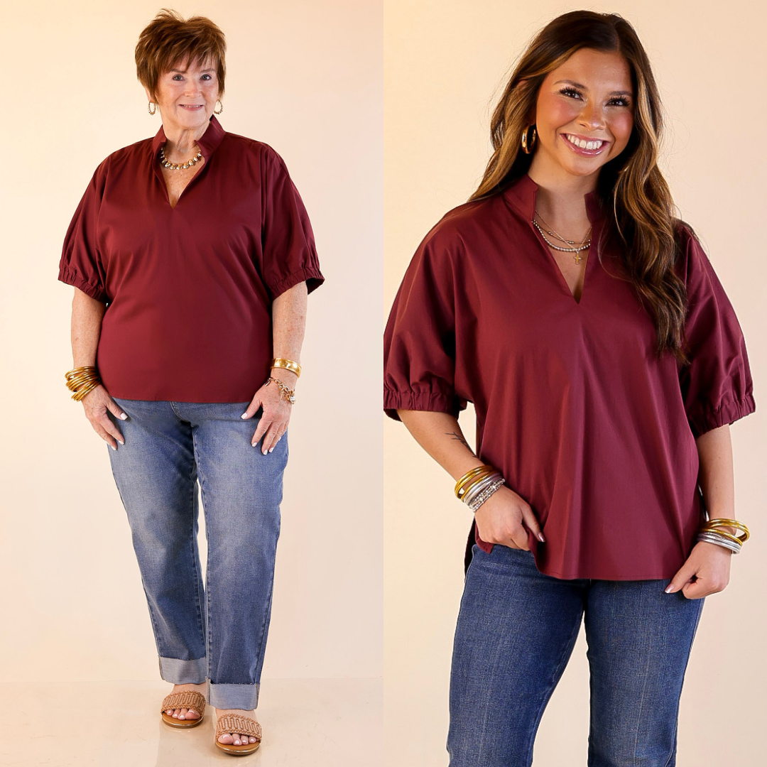 Models are wearing Maroon tops and blue jeans on a beige background