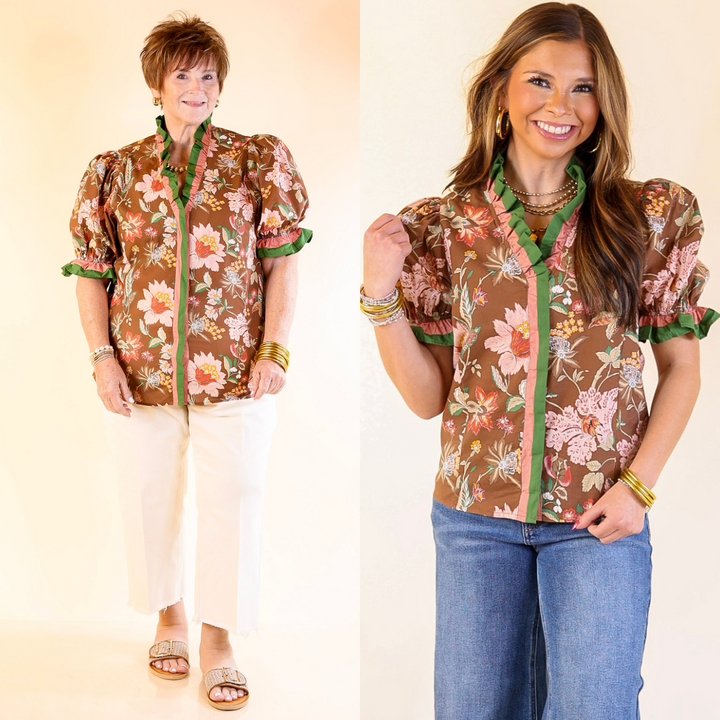Two women wearing a floral blouse with a brown base color and jeans. 