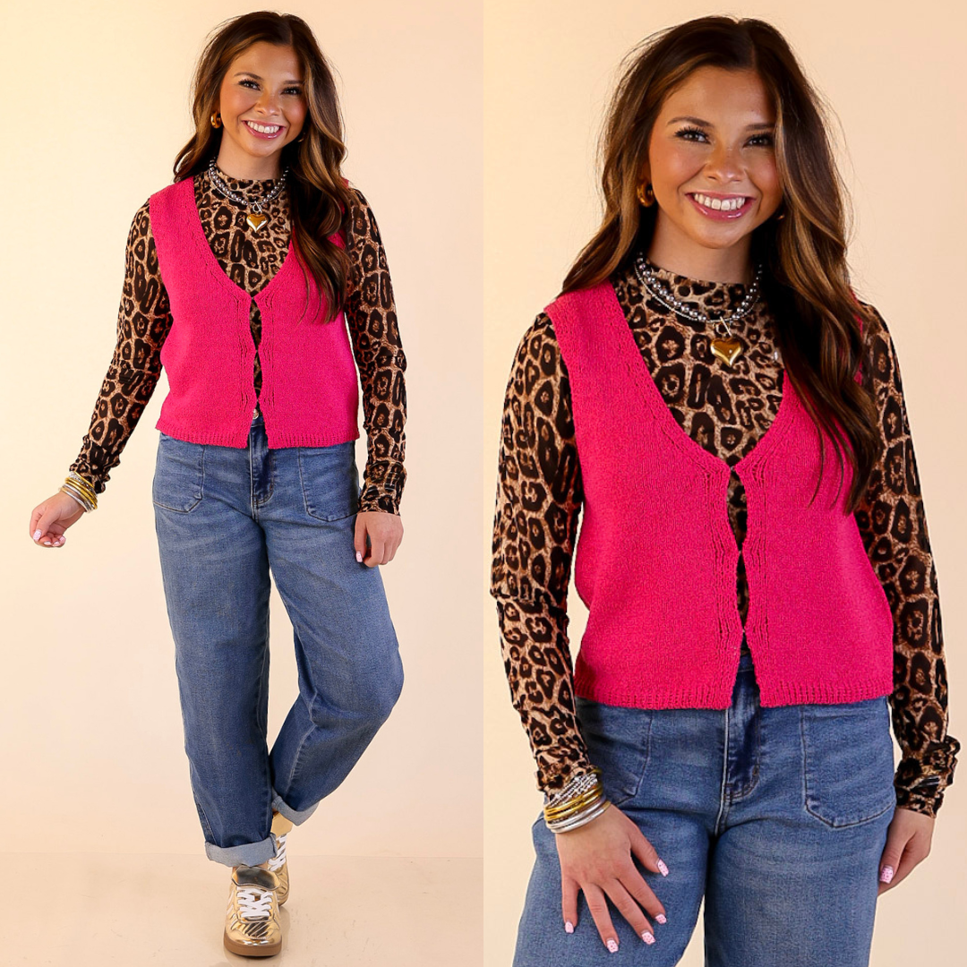 Woman wearing a leopard print long-sleeve mesh top, pink vest, and blue jeans on a beige background
