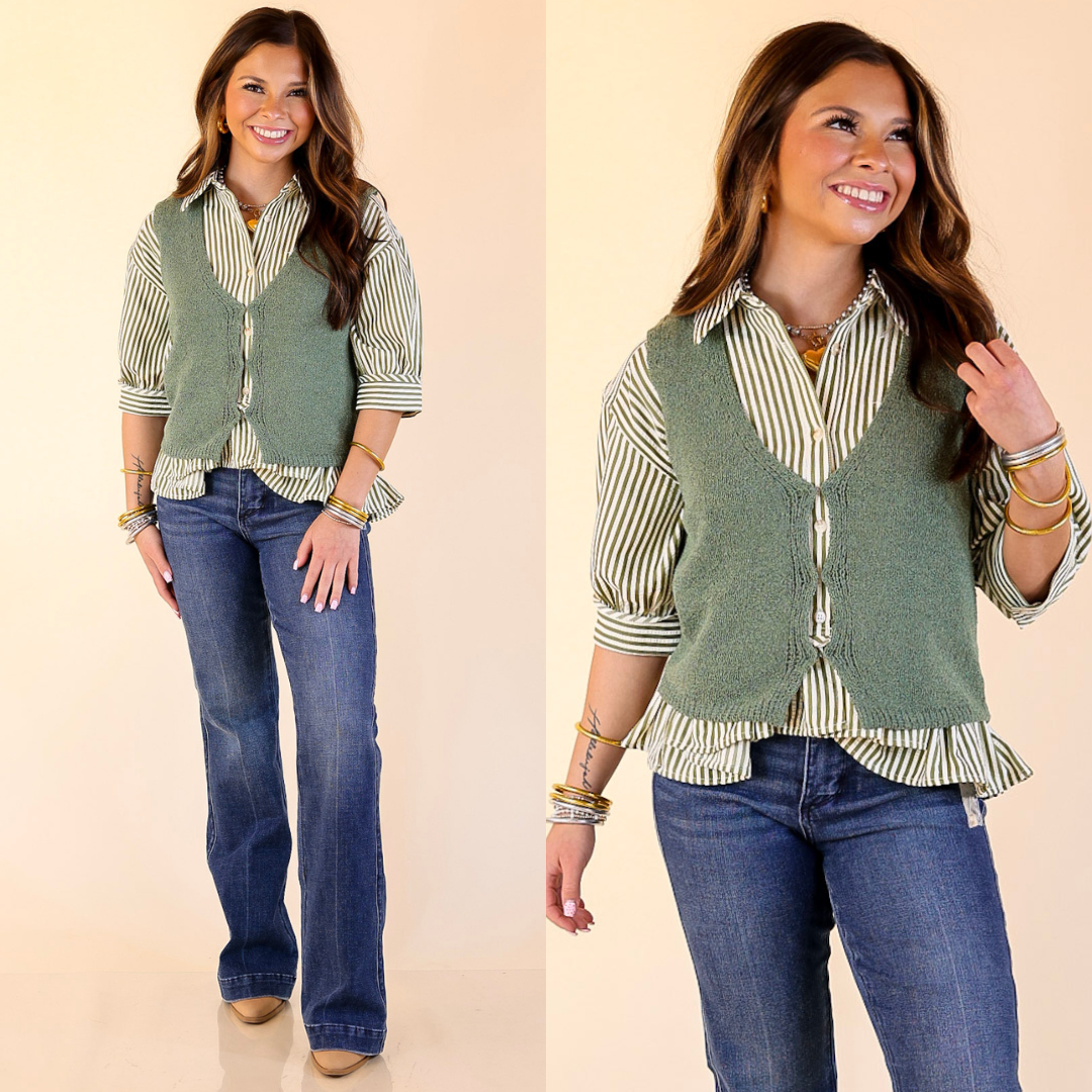 Woman wearing a olive green vest over a striped shirt with blue jeans on a beige background