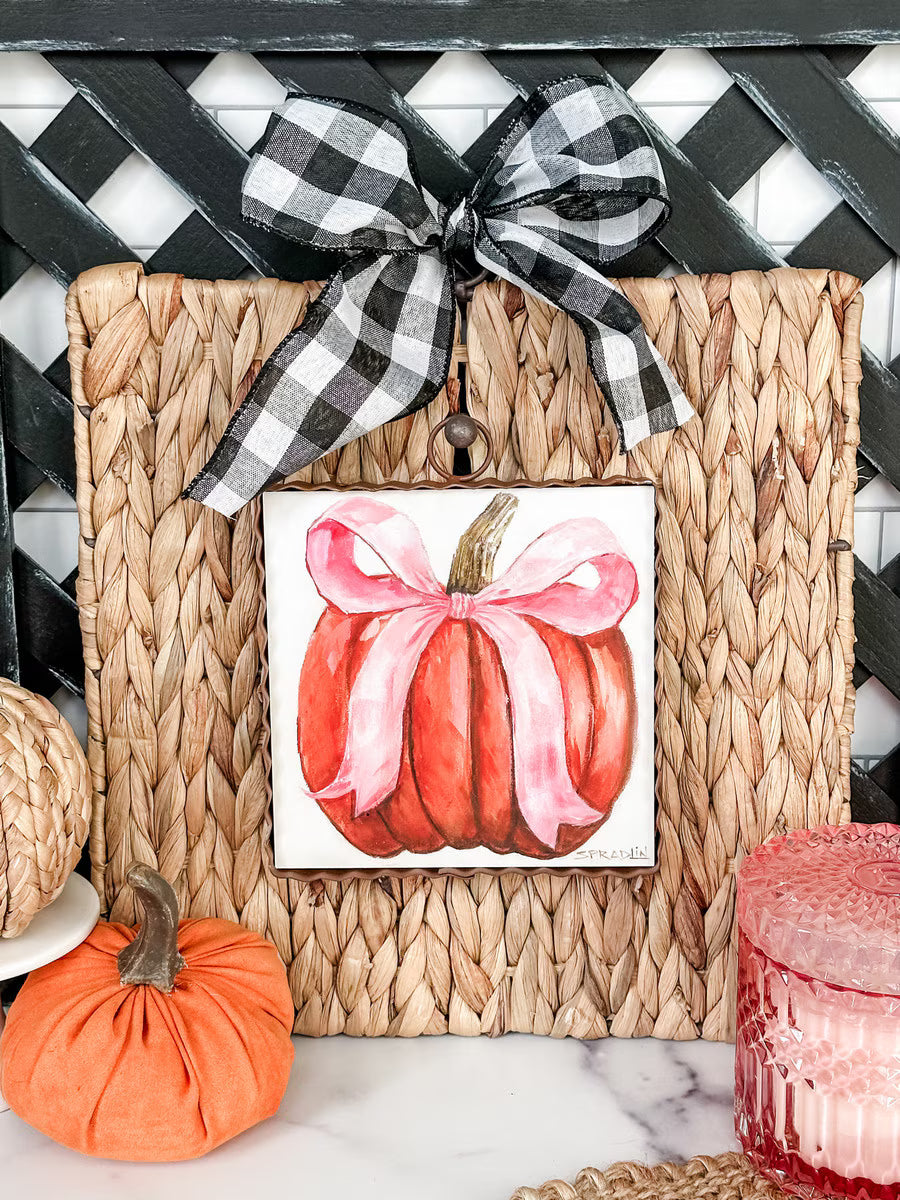 Pink Ribbon Pumpkin Mini Art Gallery by The Round Top Collection styled on a woven display board with black and white gingham bow and fall décor.