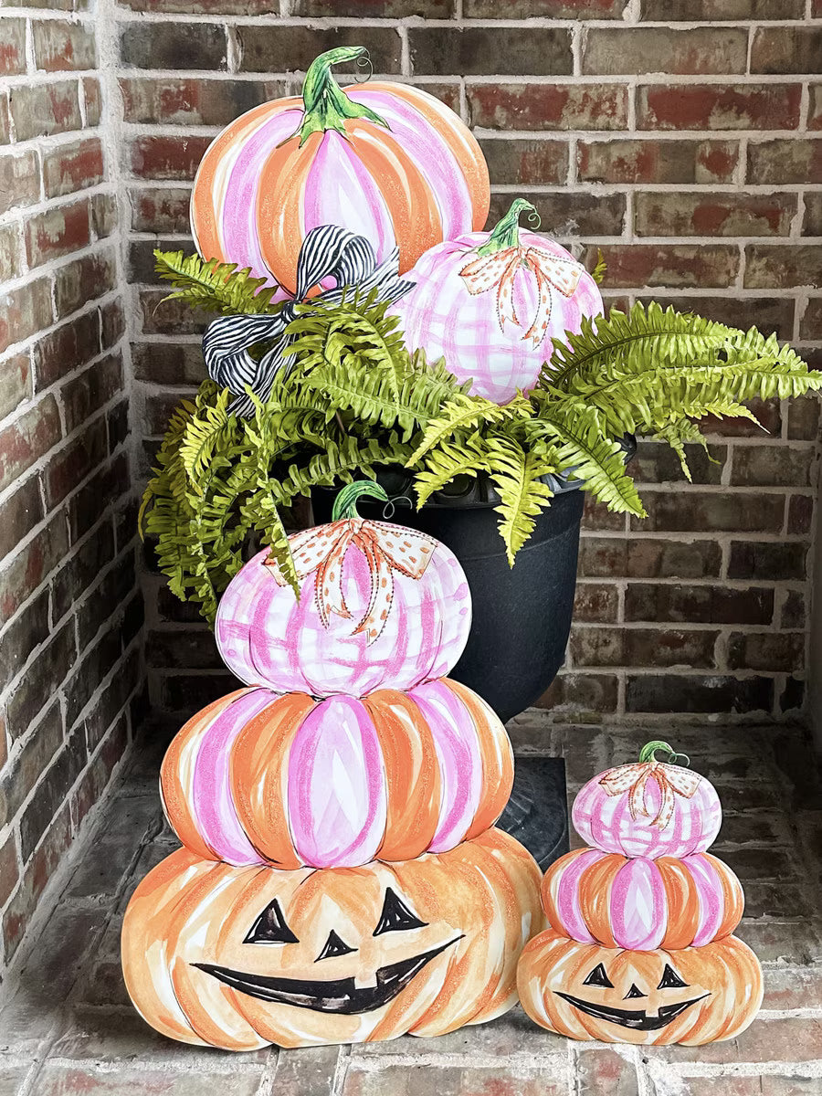 Large Pink Pumpkin Stack by Roseanne Beck displayed on a Halloween porch with coordinating pink and orange pumpkin decorations.