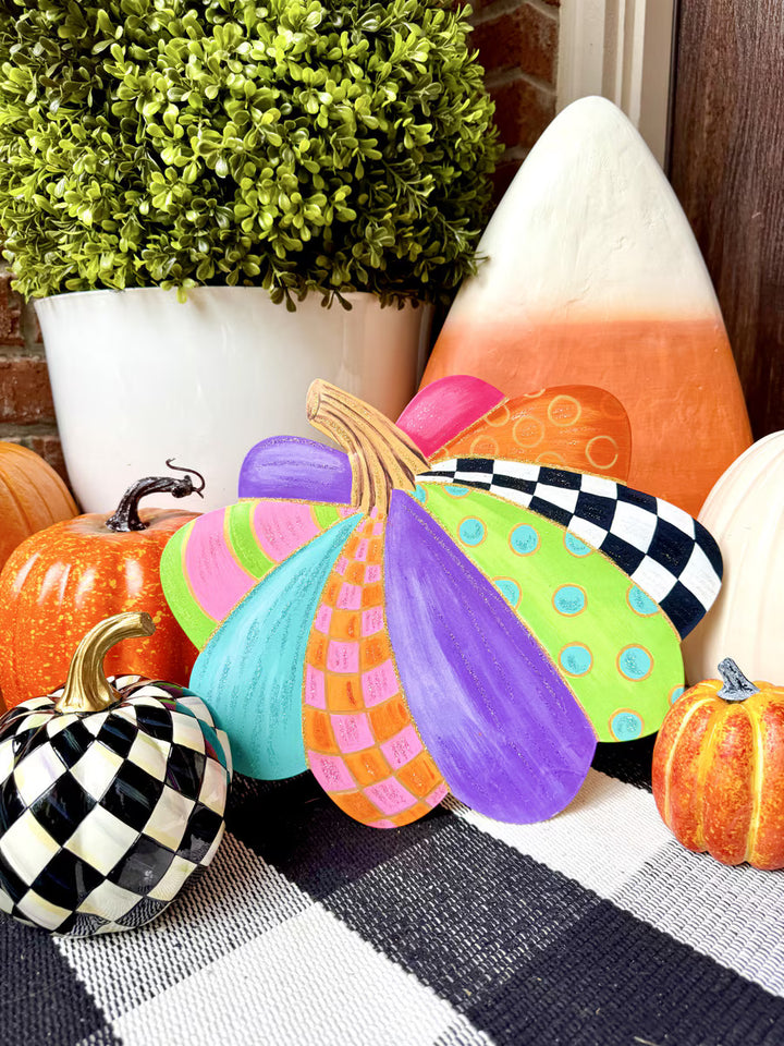 Colorful Small Party Pumpkin by The Round Top Collection styled with black-and-white checkered and orange pumpkins for whimsical fall porch decor.