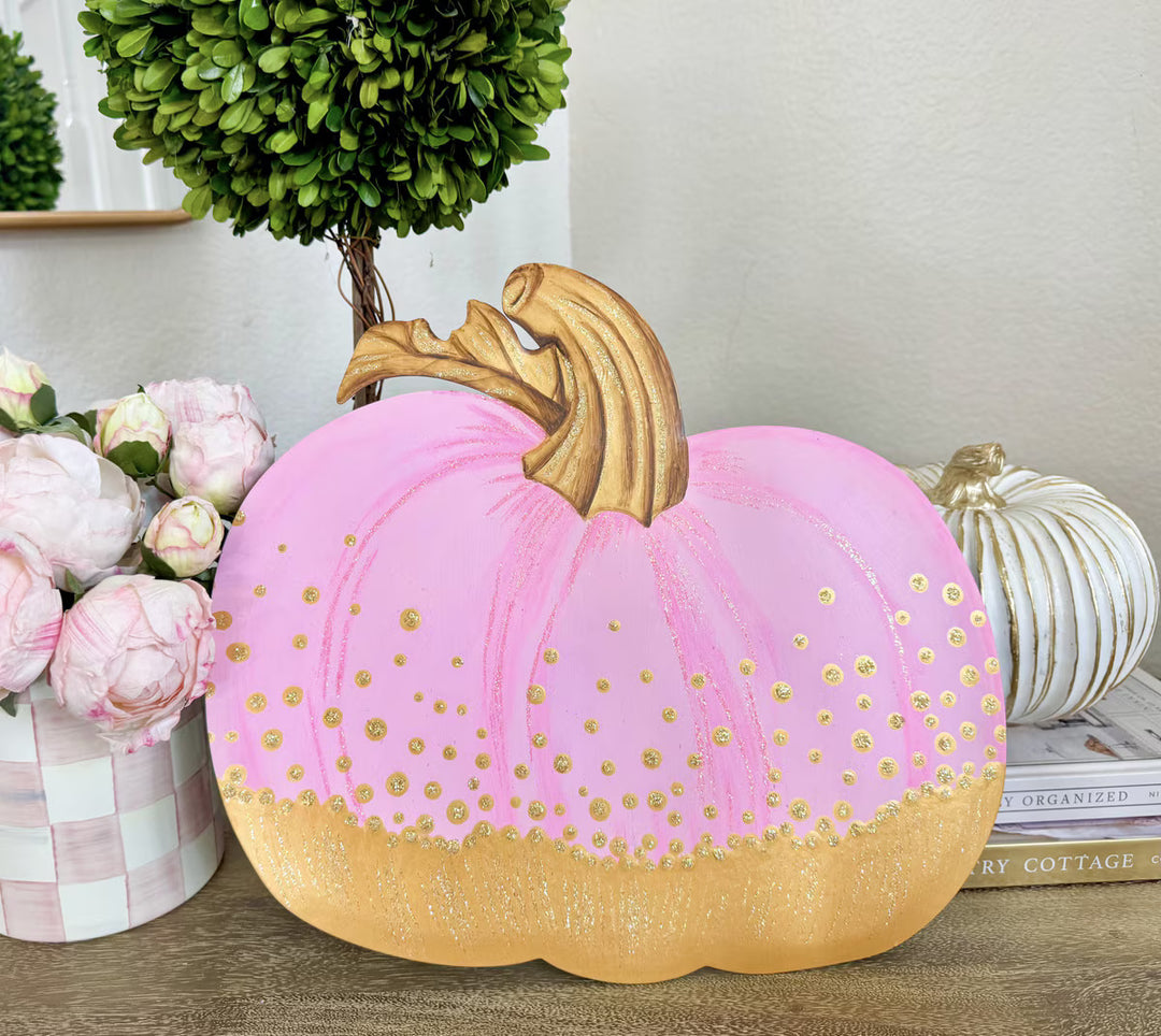 Round Top Collection Pink and Gold Pumpkin with soft pink finish, glittery gold bottom and sculptural gold stem displayed indoors.