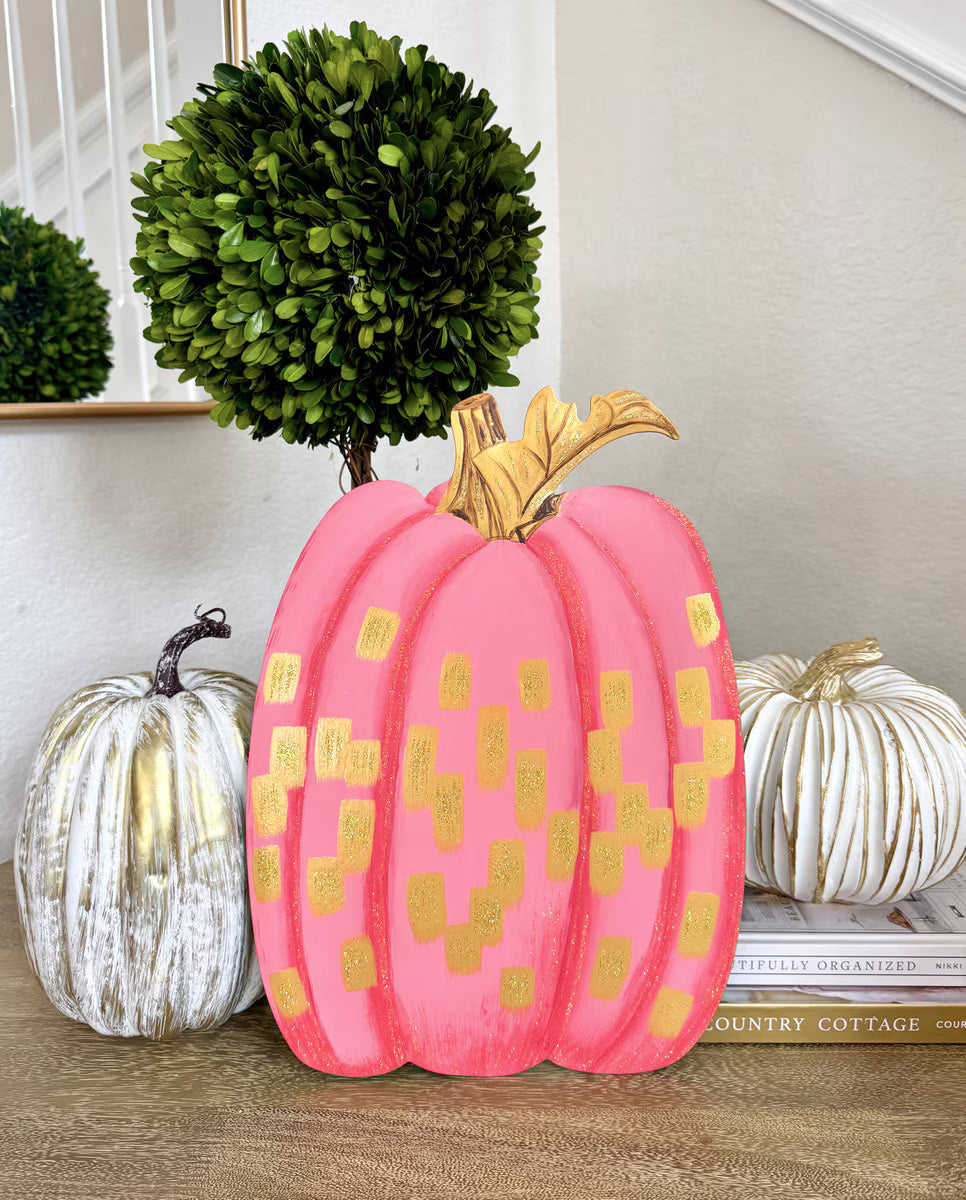 Gold and Hot Pink Pumpkin by The Round Top Collection displayed indoors with white and gold pumpkins and green topiary for girly fall decor.