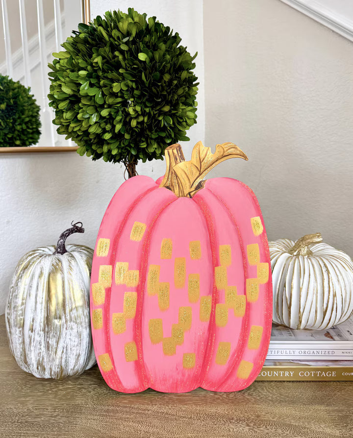 Gold and Hot Pink Pumpkin by The Round Top Collection displayed indoors with white and gold pumpkins and green topiary for girly fall decor.