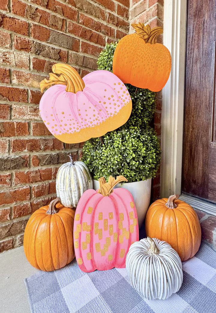 Pink and gold Round Top Collection pumpkin displayed with coordinating pink, orange and white pumpkins in a colorful fall front porch arrangement.