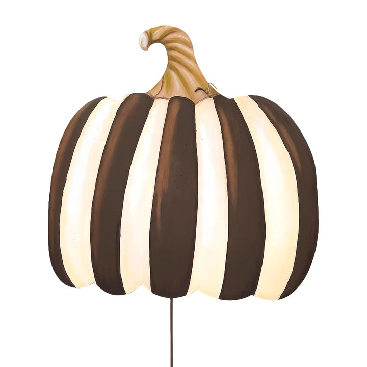 brown and ivory striped pumpkin on a garden stake