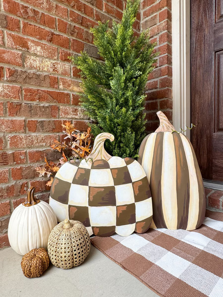 Chocolate striped and checked pumpkins by The Round Top Collection styled together on a fall porch with neutral pumpkins and autumn décor.