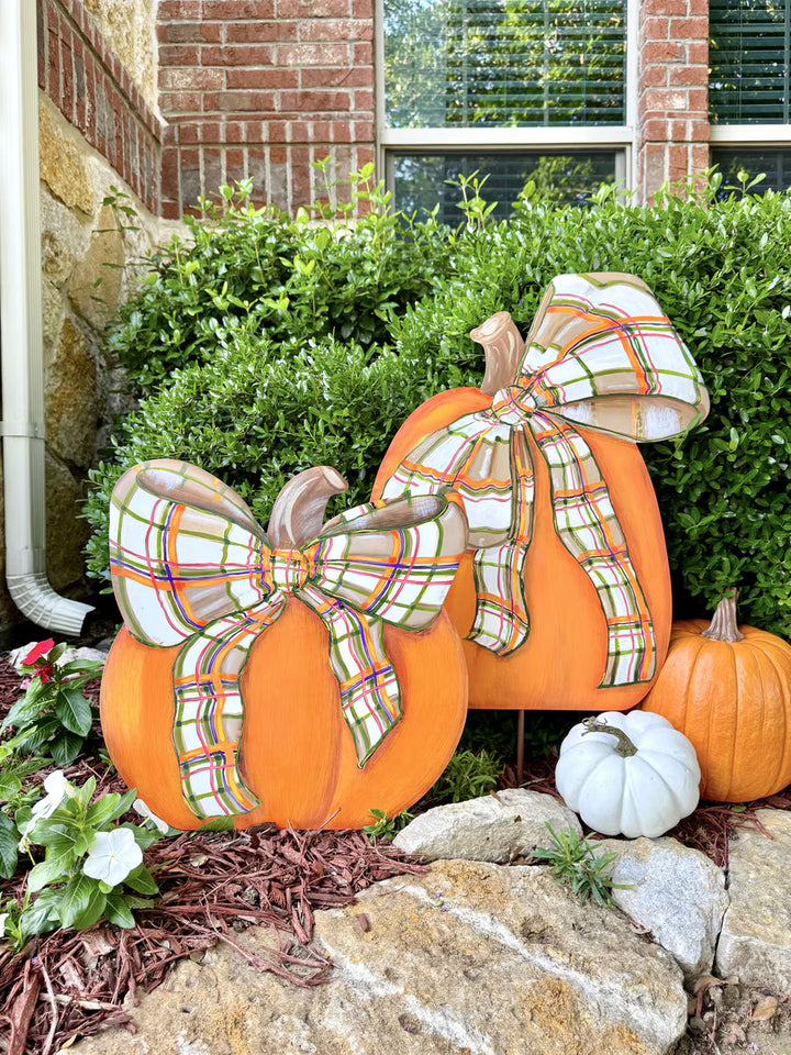 Short and Tall Modern Plaid Pumpkins with bows by The Round Top Collection displayed outdoors with fall pumpkins and greenery.