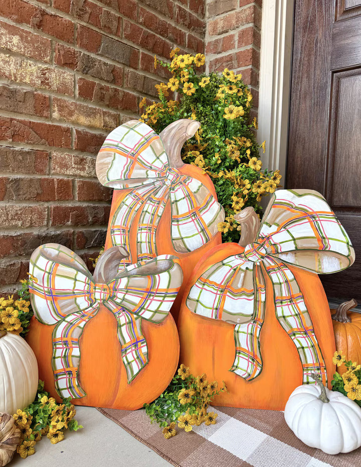 Modern Plaid Pumpkins by The Round Top Collection featuring orange pumpkins with oversized plaid bows styled together on a fall porch.