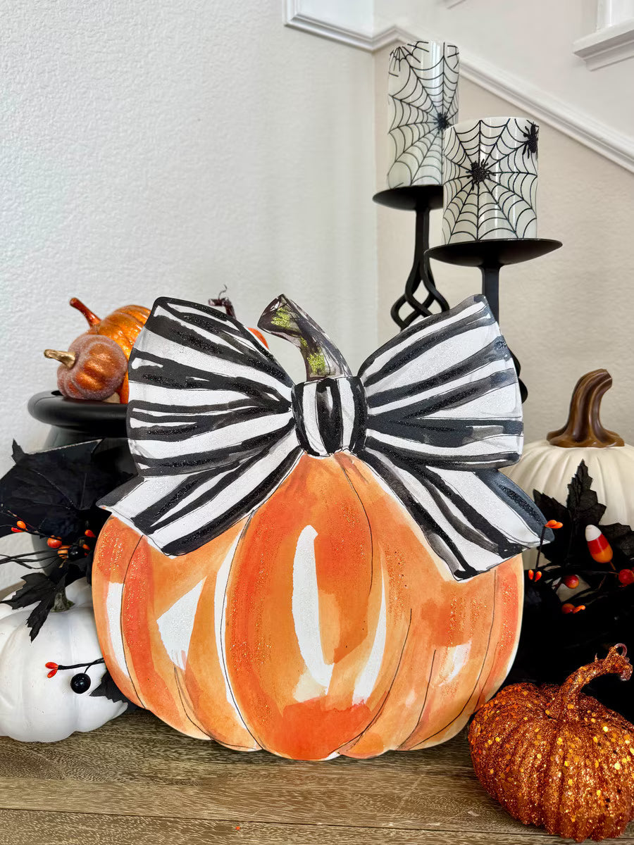 Spooky Pumpkin by The Round Top Collection with oversized black and white striped bow and glitter accents styled with Halloween decorations.