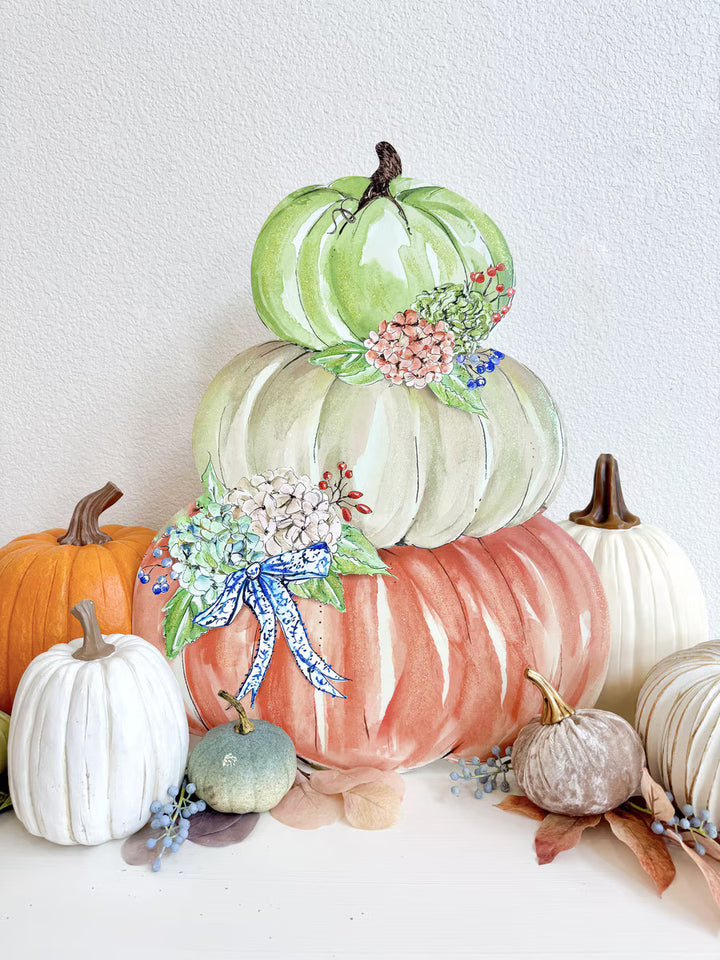 Autumn Feast Pumpkin Stack by Rosanne Beck featuring sage, neutral and coral pumpkins with hydrangeas and blue bow styled with fall décor.