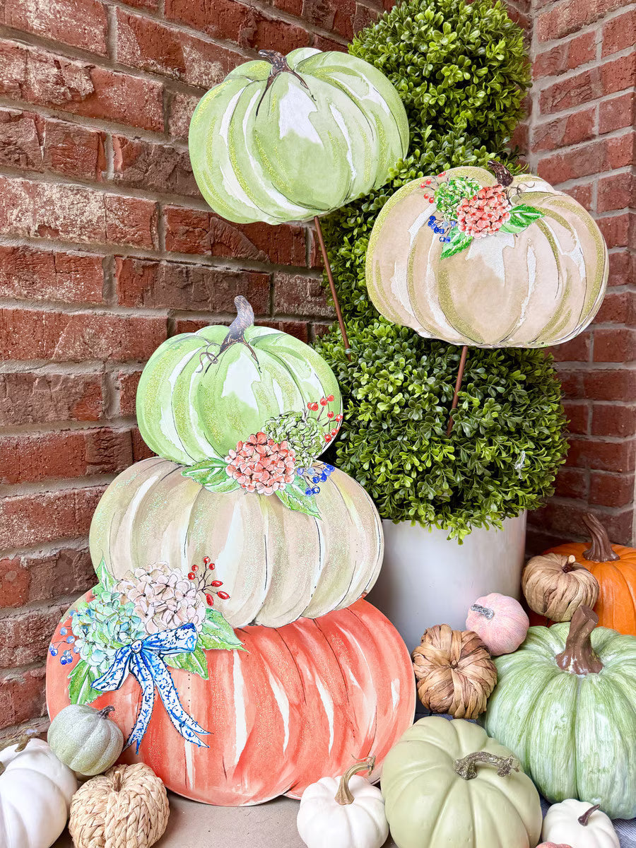 Rosanne Beck Autumn Feast Pumpkin Stack by The Round Top Collection styled with greenery and assorted fall pumpkins on a brick porch.