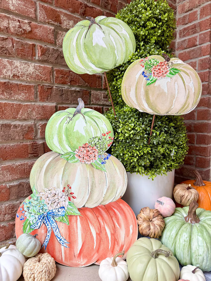 Rosanne Beck Autumn Feast Pumpkin Stack by The Round Top Collection styled with greenery and assorted fall pumpkins on a brick porch.