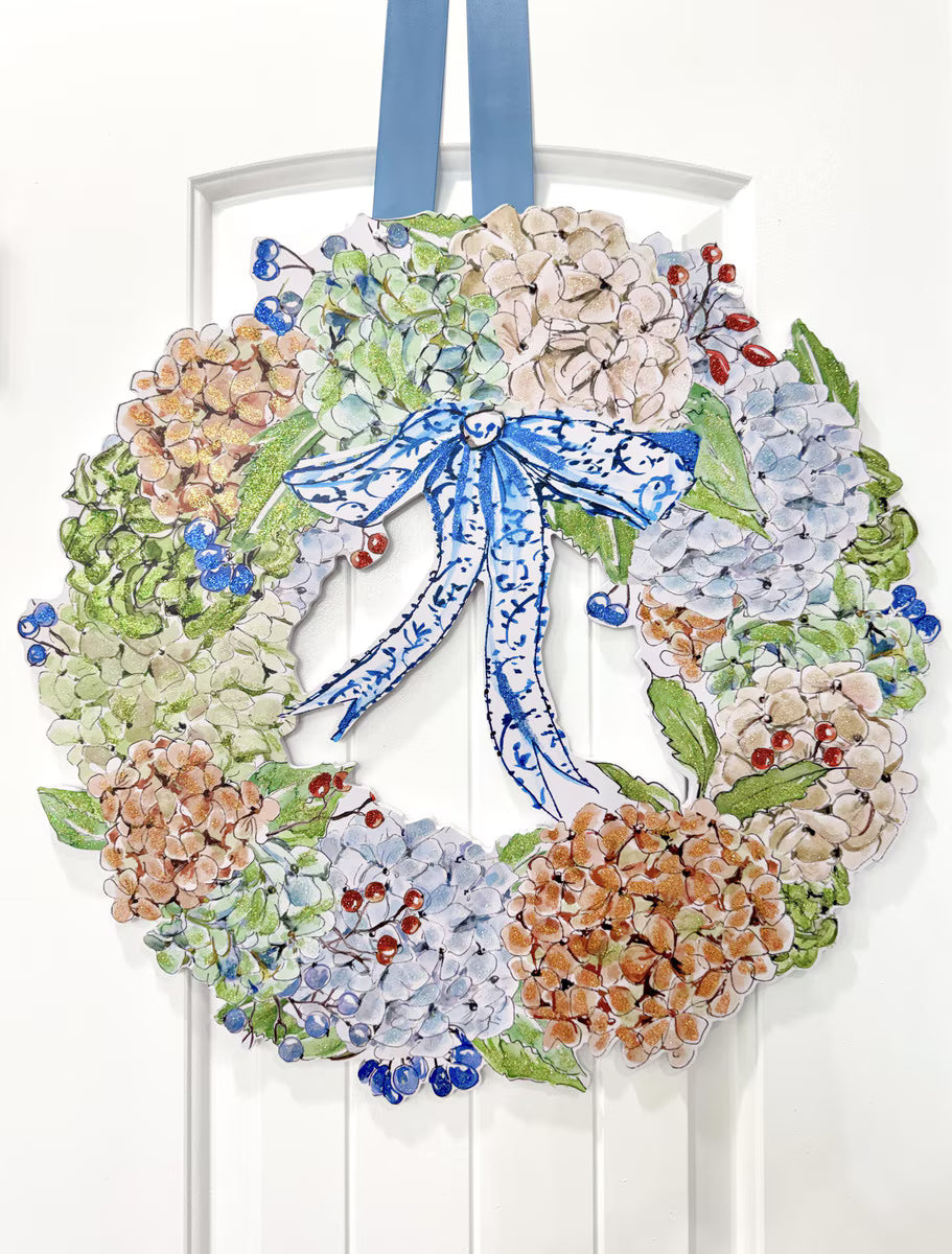 Rosanne Beck Autumn Hydrangea Wreath Door Hanger by The Round Top Collection featuring colorful hydrangeas and a blue-and-white bow displayed on a white door.