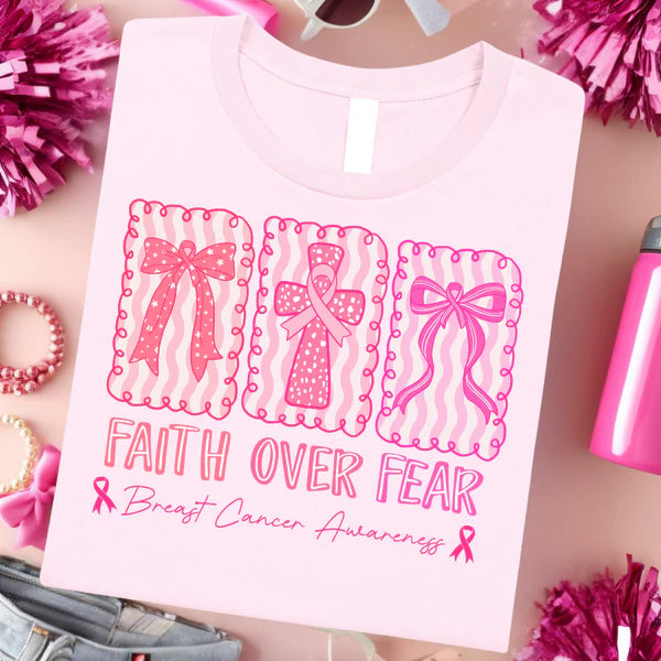 Pink t-shirt with 'Faith Over Fear' text and breast cancer awareness design on a pink background.