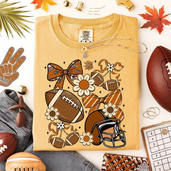 Yellow t-shirt with football and bow design on a white background with sports-themed accessories.