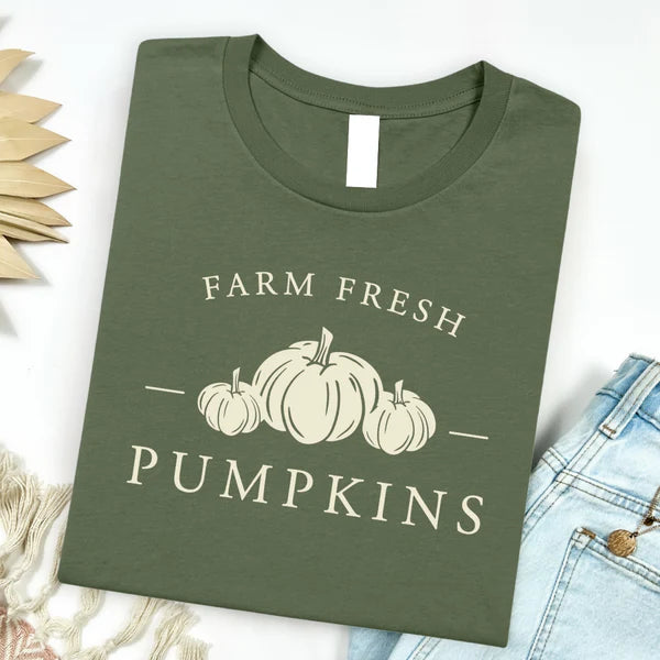 Green t-shirt with 'Farm Fresh Pumpkins' text and pumpkin graphics on a white background