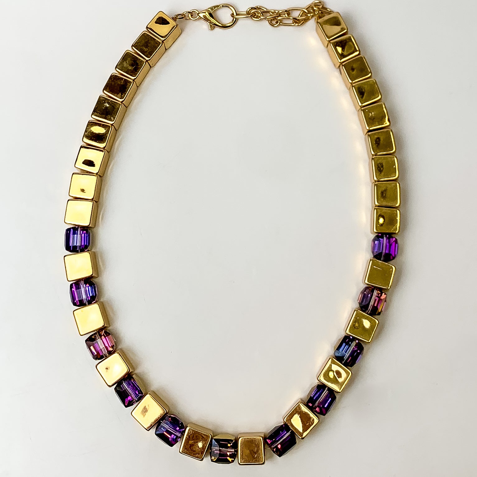 This Fashionably Late Gold Tone Cubed Necklace in Purple is pictured on a white background.