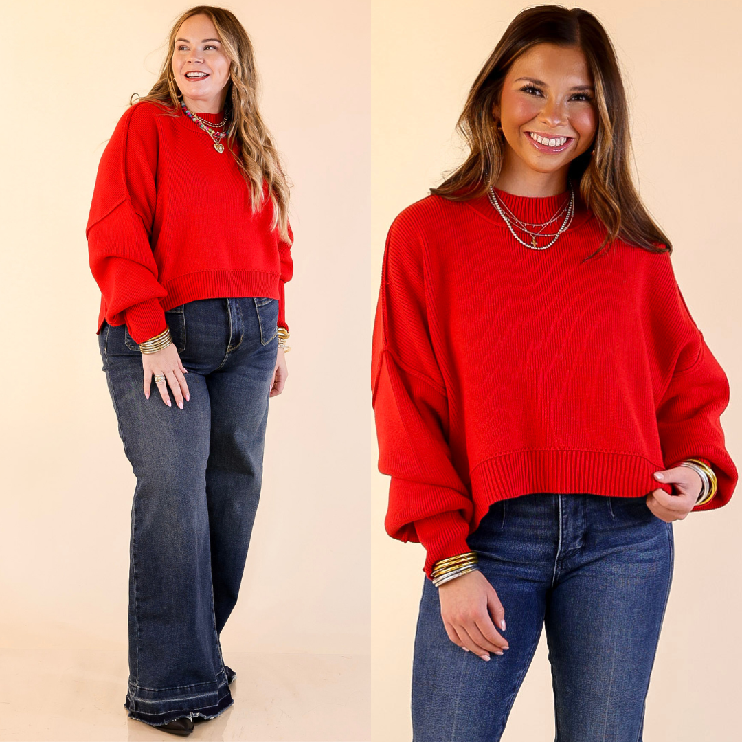 Two models wearing the Red 'Fireside Fit' cropped long sleeve mock neck sweater with jeans. Against a plain background.