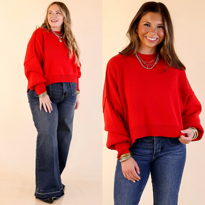 Two models wearing the Red 'Fireside Fit' cropped long sleeve mock neck sweater with jeans. Against a plain background.