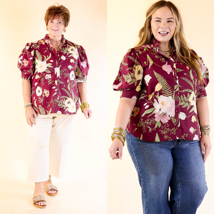 Two women wearing maroon floral shirts on a plain background