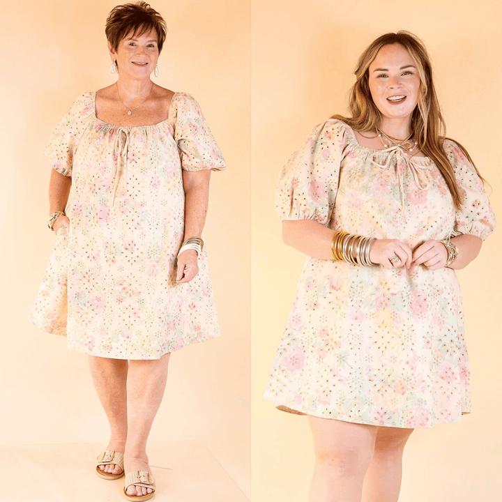 Floral and feminine, this eyelet lace A-line dress features puff sleeves, a square neck, front bow tie, and hidden pockets. Sizes small through plus sizes.